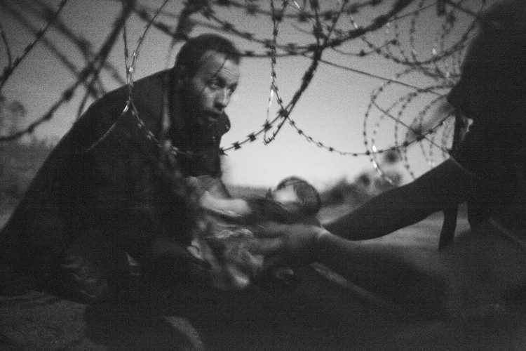 W. Richardson. Hope of a New Life / Migrants crossing the border from Serbia into Hungary.